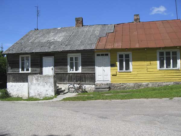 Only the unpainted left side of the house is now occupied.